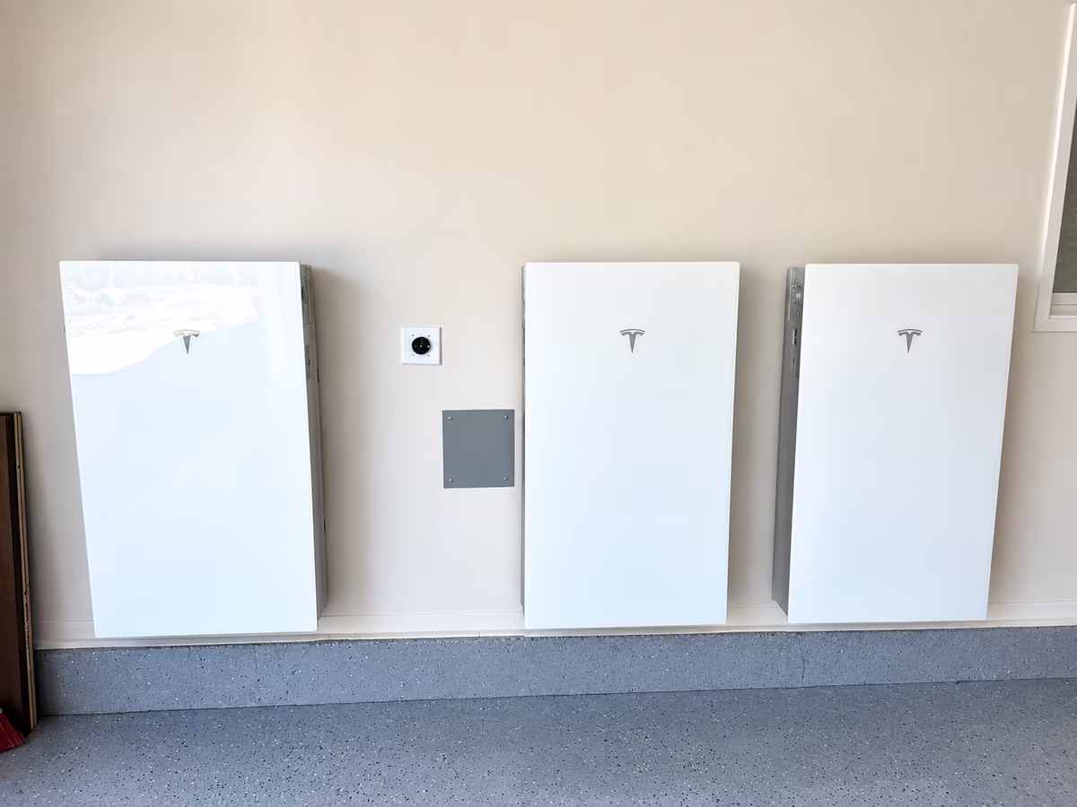 Three Tesla Powerwall 3 units installed in a home garage