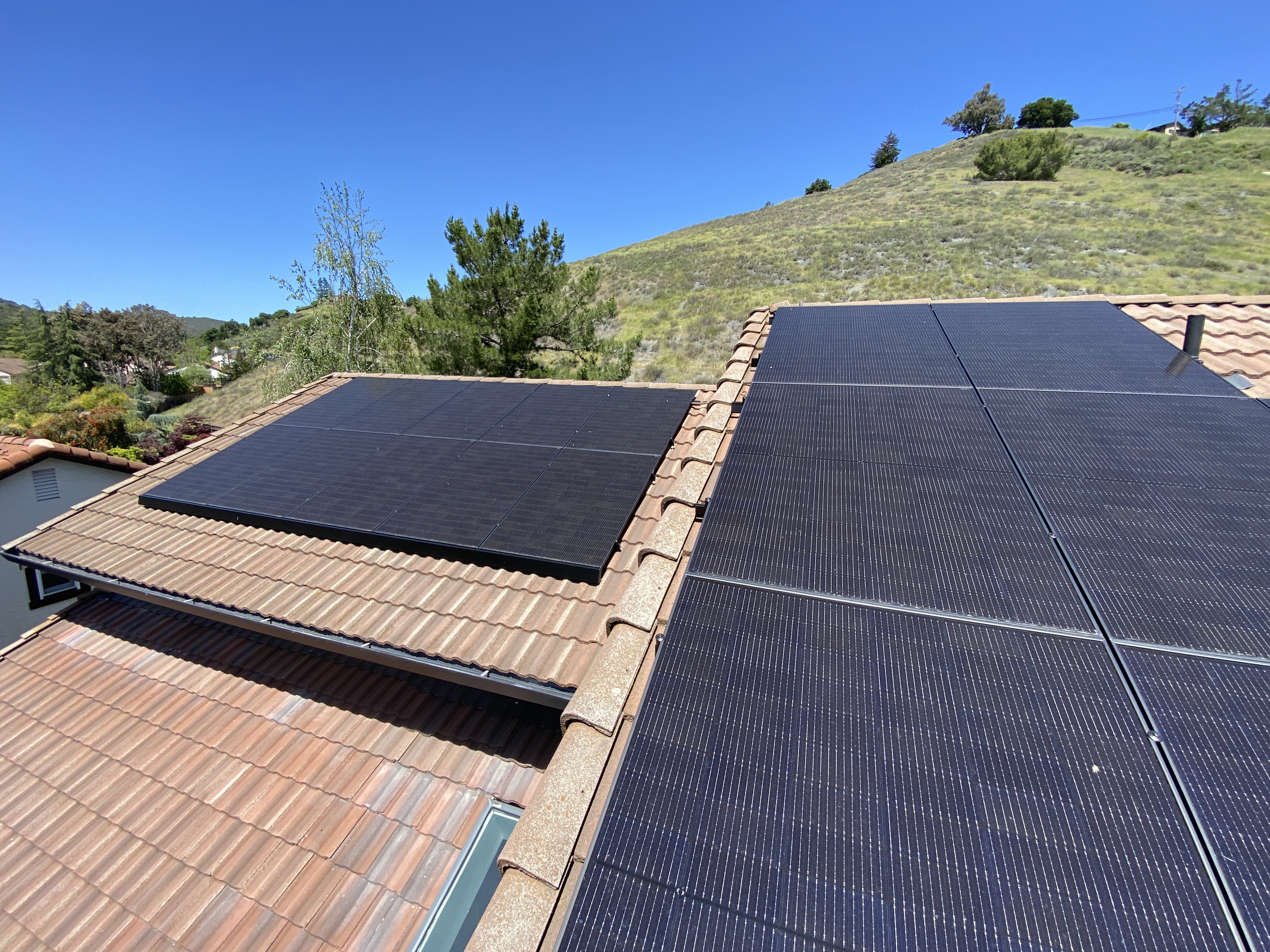Solar panels spanning multiple sections of the tile roof array