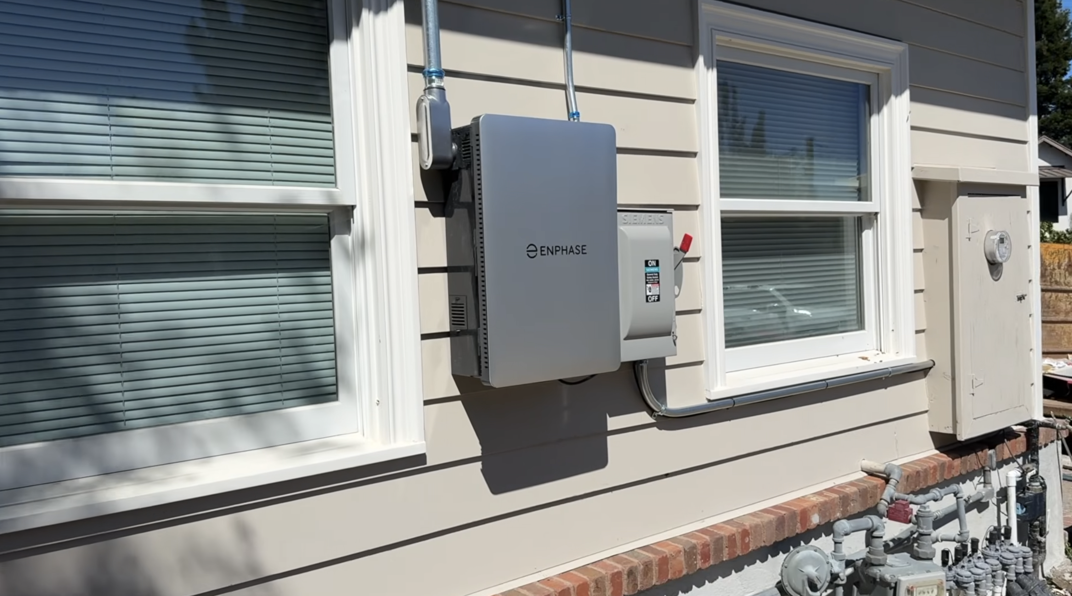 Enphase combiner box and disconnect switch mounted on the exterior wall